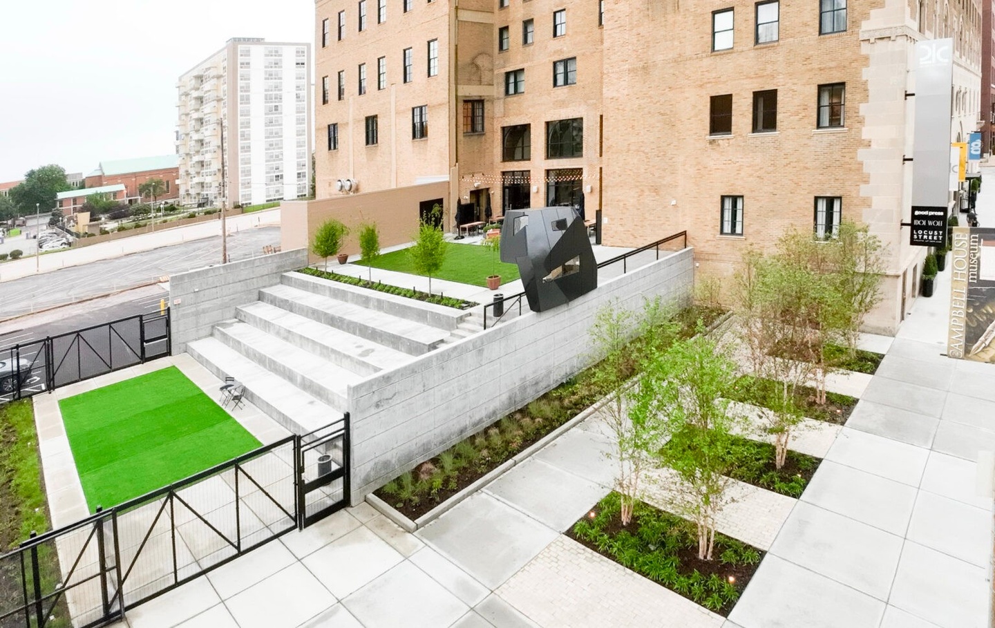 Elevated view of hotel courtyard, showing sculpture at center.