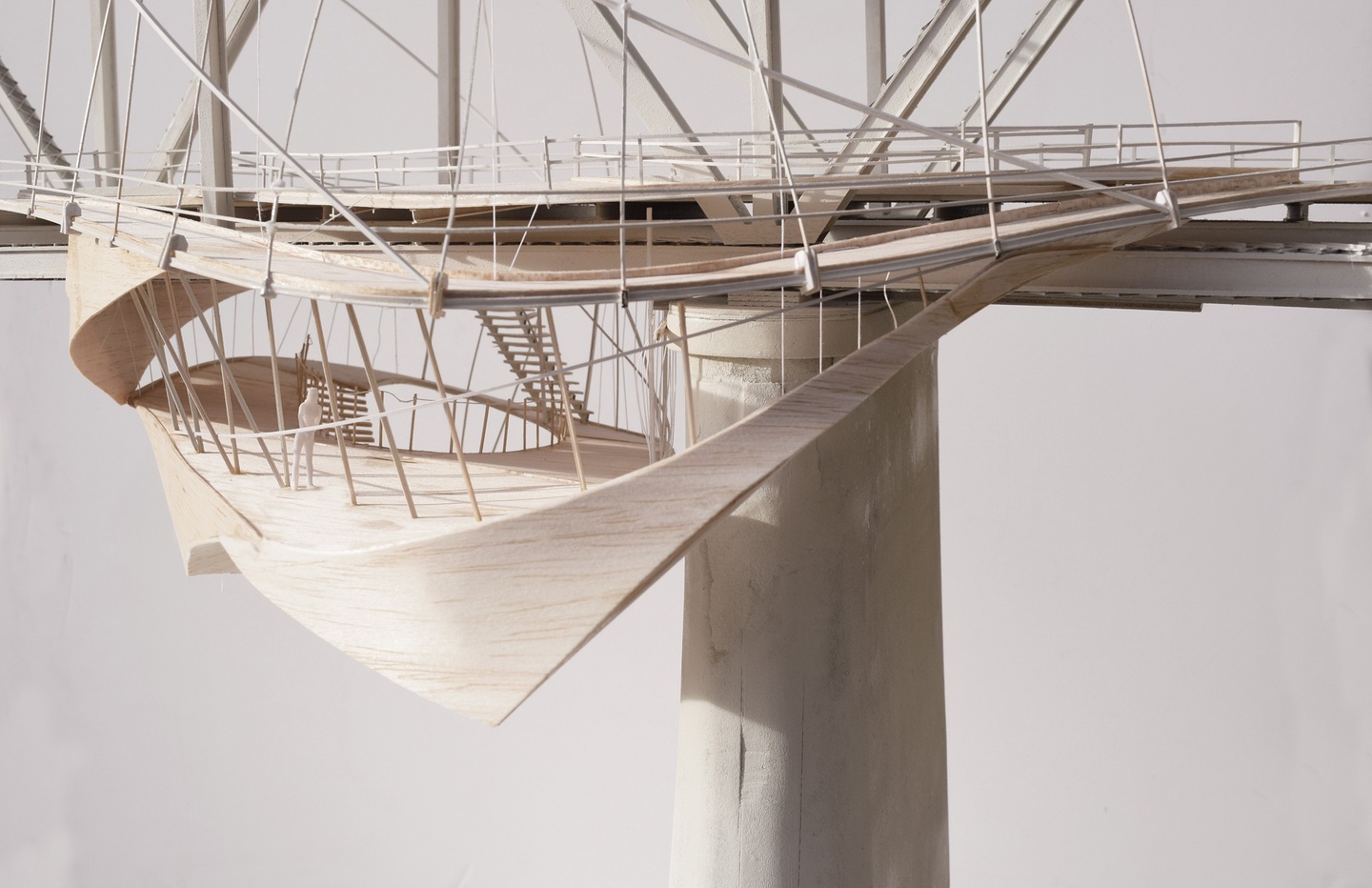 Basswood model of a steel truss bridge with a canoe-shaped observation deck suspended from the side.