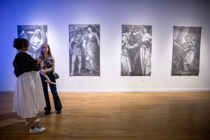 Visitors in front of 4 black and white abstract prints by Seulki Seo