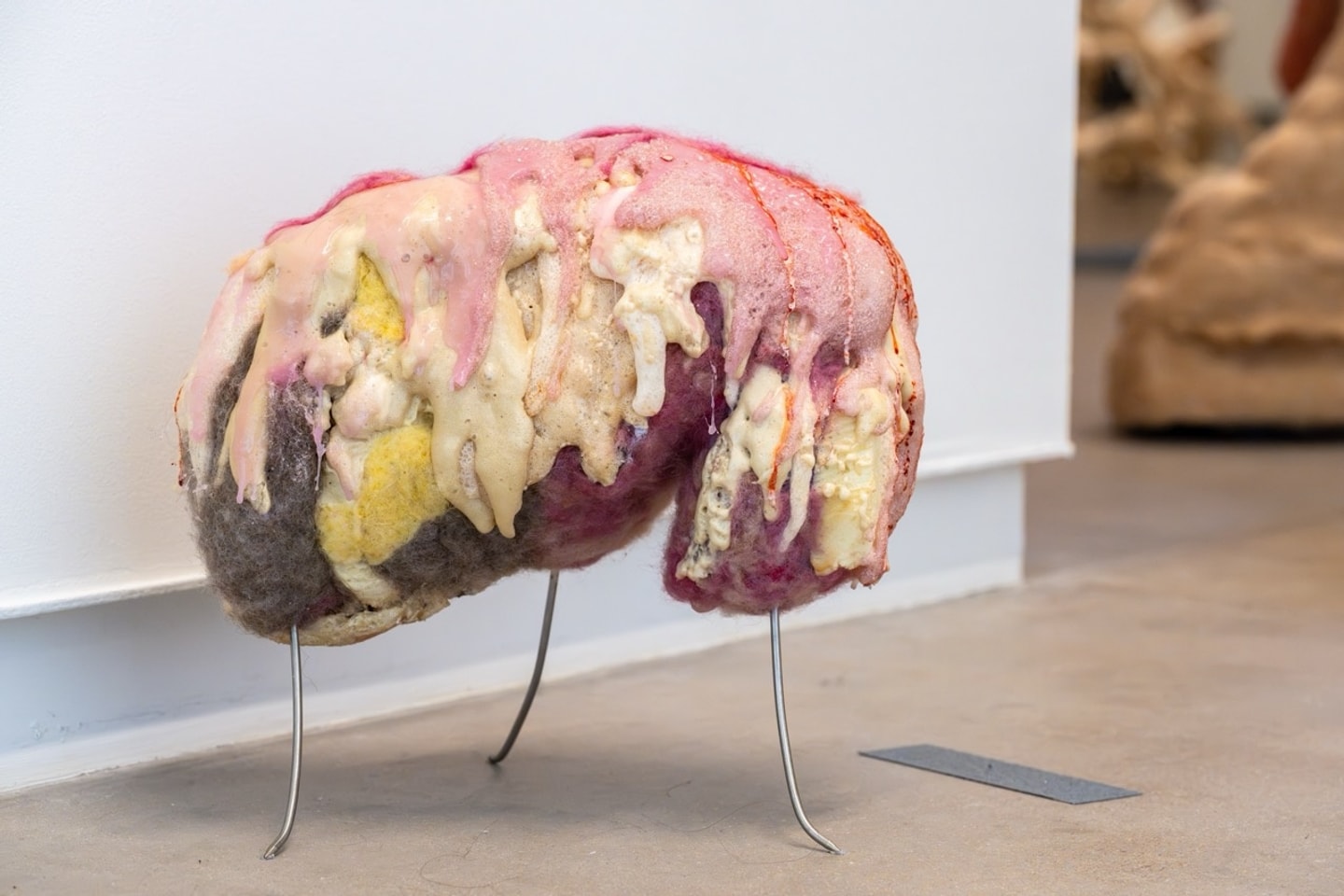 close of of a life size felted figure in a variety of colors