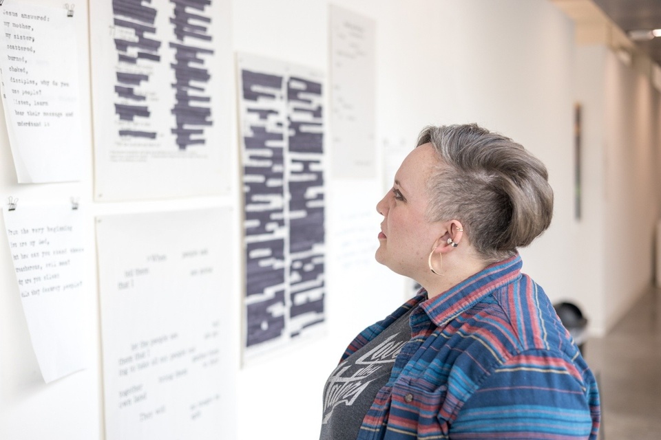 Megan Kenyon looking at her art in her studio