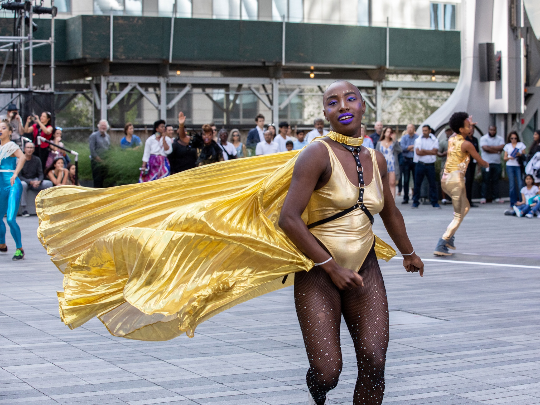 Ebony Noelle Golden running in metallic cape.
