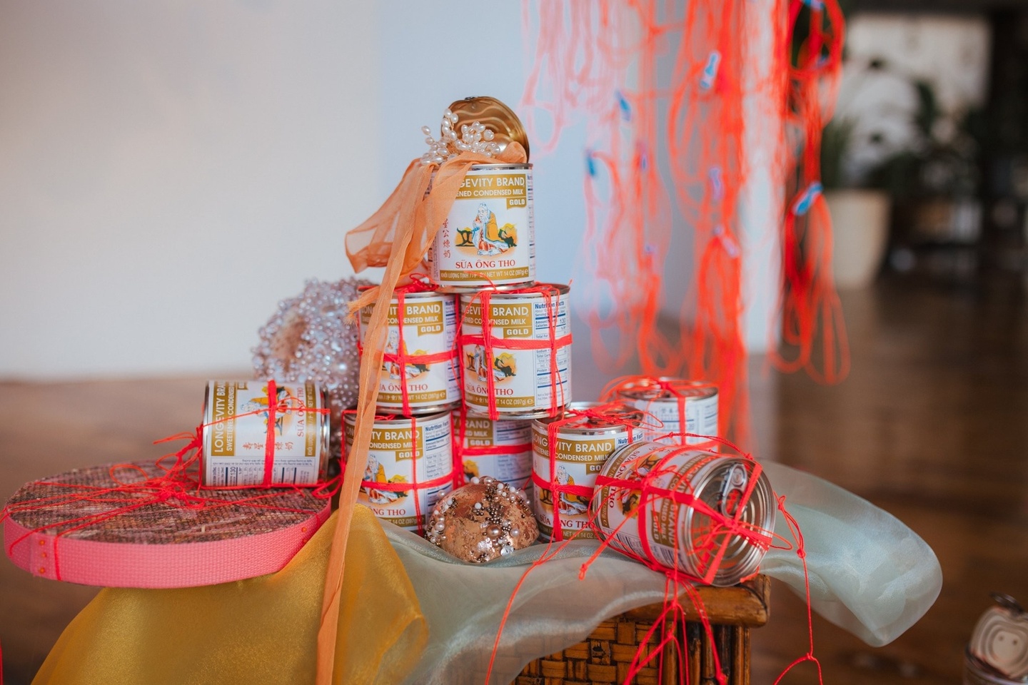 stack of condensed milk can wrapped in ribbon