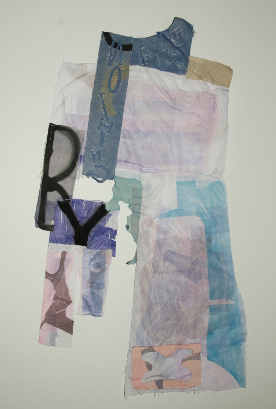 A collage of fabrics in hues of blues and purples. There are sewn letters spelling out 'Nothing'