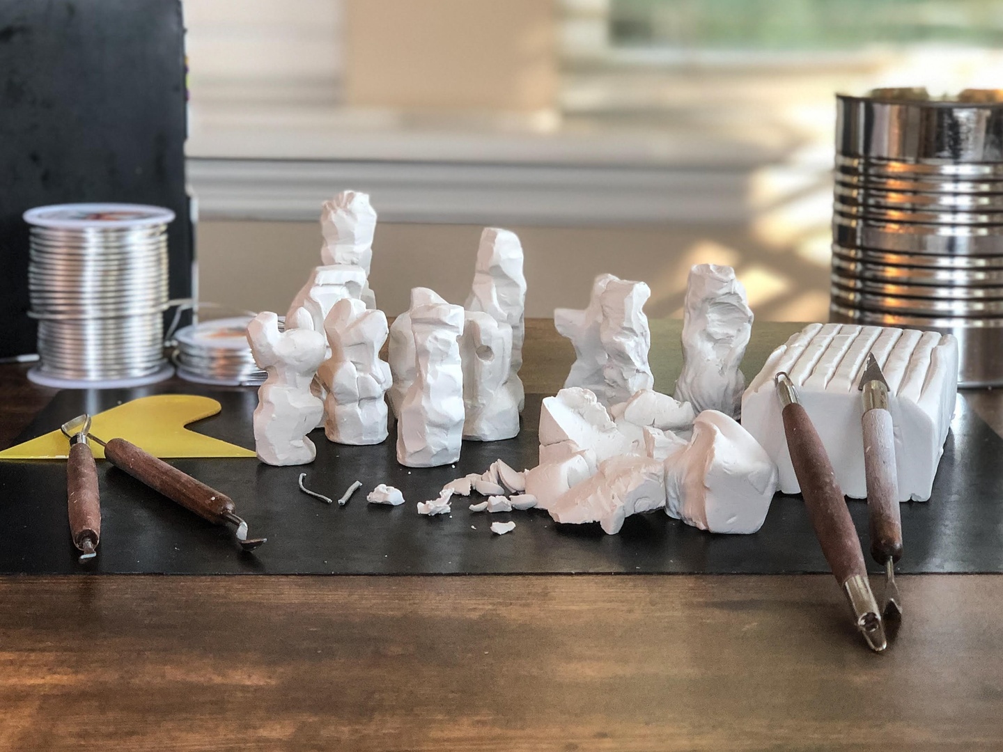 Closeup view of white polymer clay and tools on a table