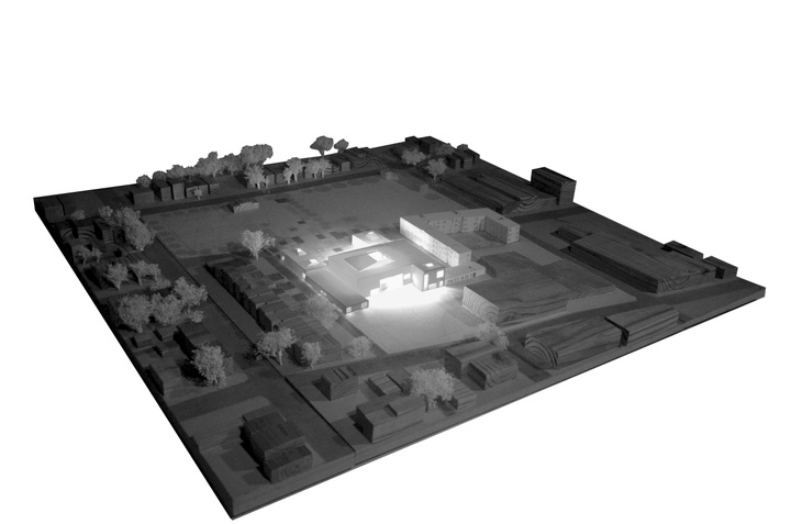 A picture of a site model that shows a glowing building in the middle of the site. 