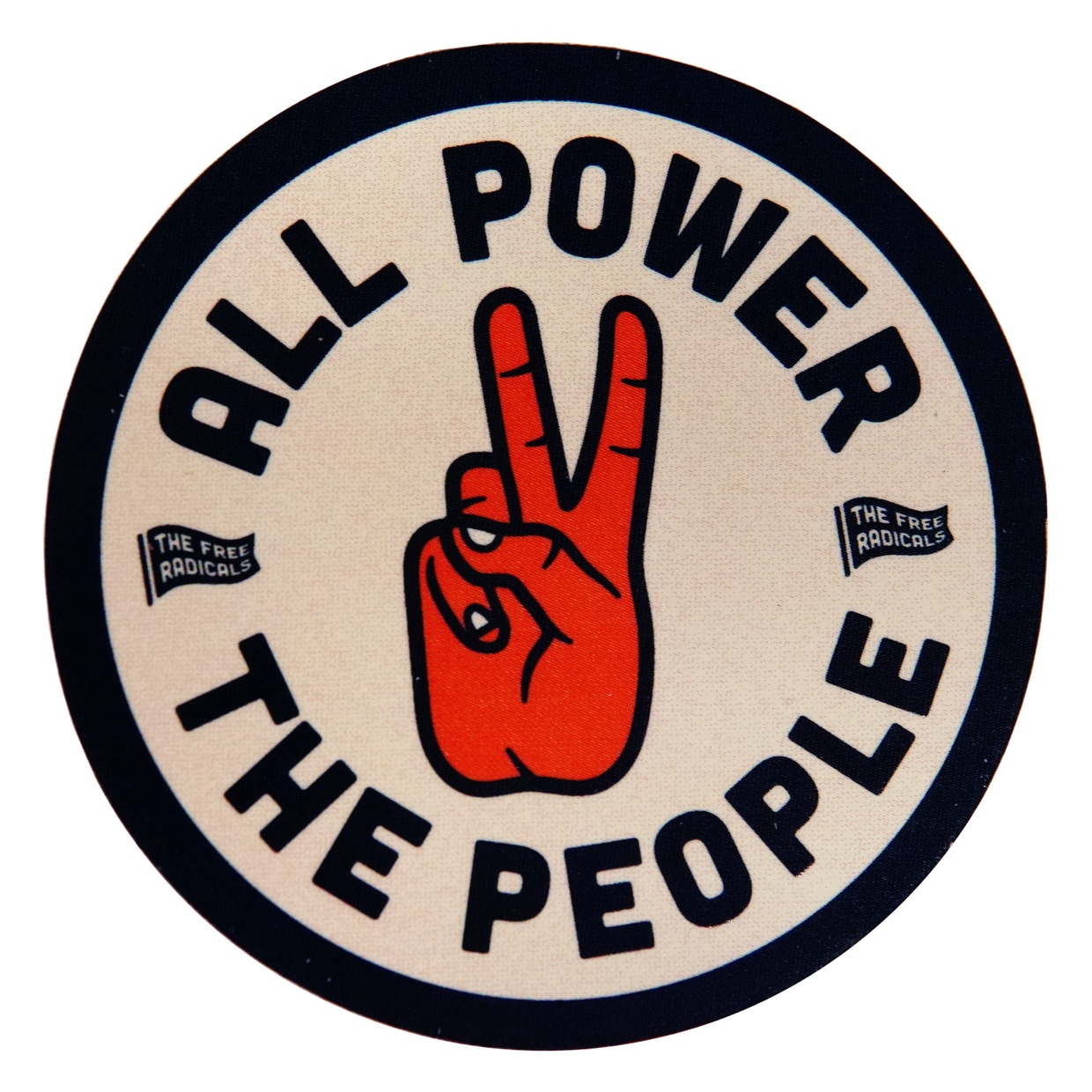 A circular white button with the words “All Power The People” and a red hand making a peace sign (that also acts as the word “to”) in the center.
