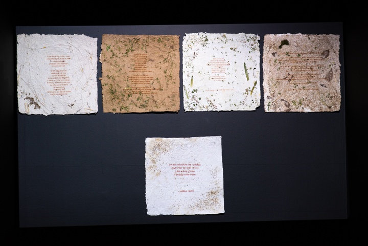 Five sheets of handmade paper inlaid with leaves and wildflowers with verses printed on them.