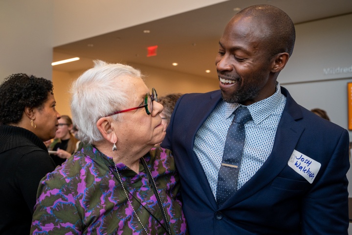 Georgia gets a one-armed hug from someone in a suit.