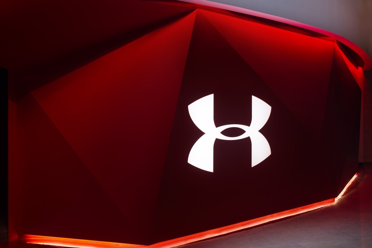 Close-up of exterior red wall of brand experience, with Under Armour logo