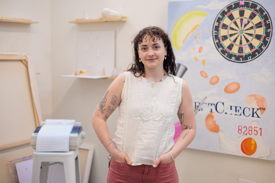artist Grace Ryder sitting at a table working on ceramic tears