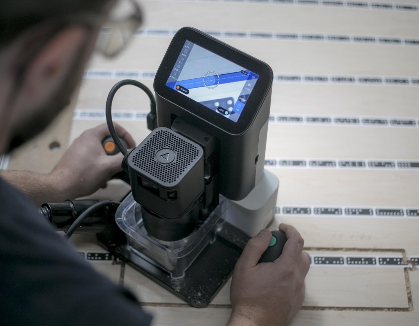 View from over the shoulder of someone using a handheld router.