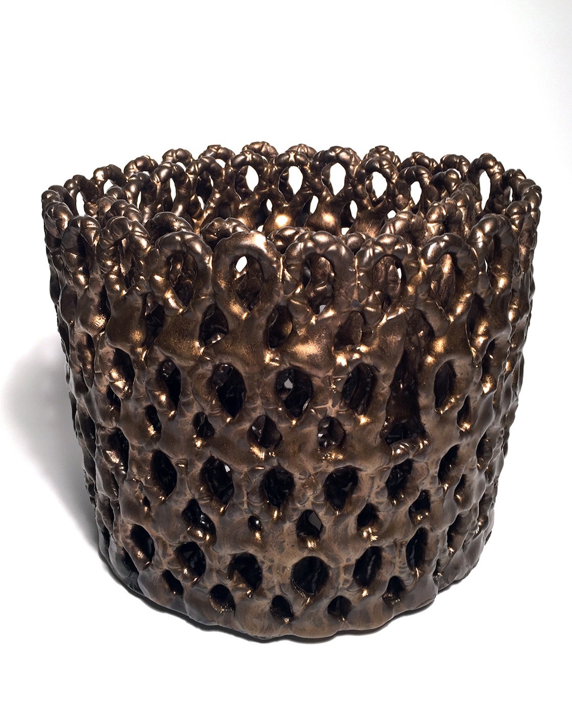 An intricately looped/patterned vessel in bronze.