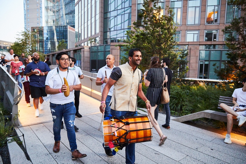 Drummers walking to outdoor stage.