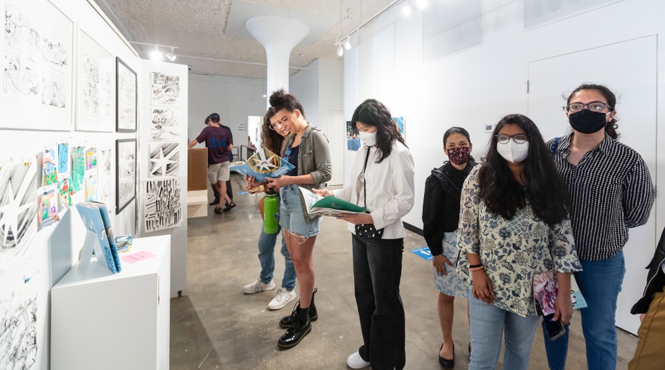 Students look at projects at the exhibition