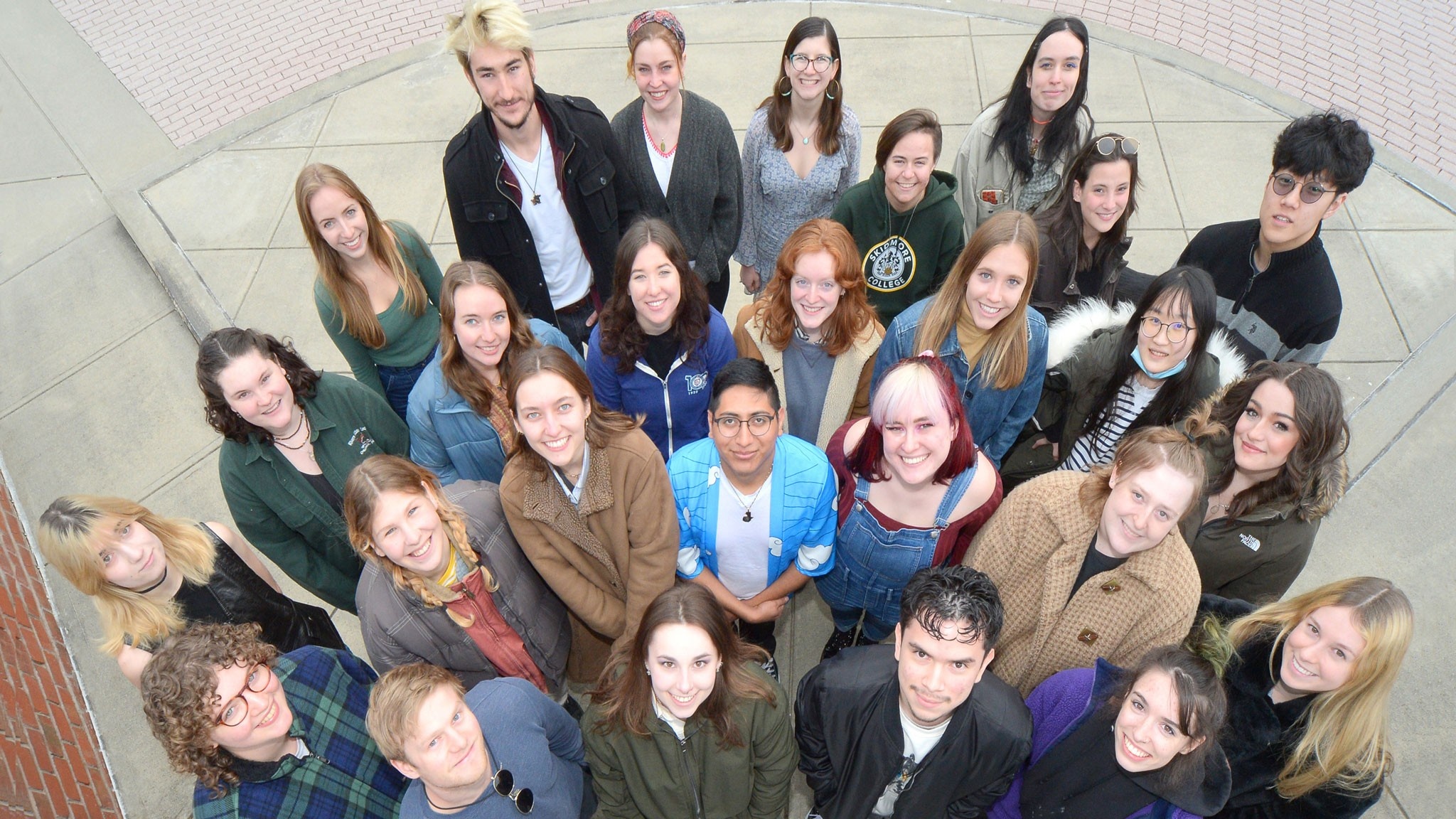 A group of students standing and looking up into the camera