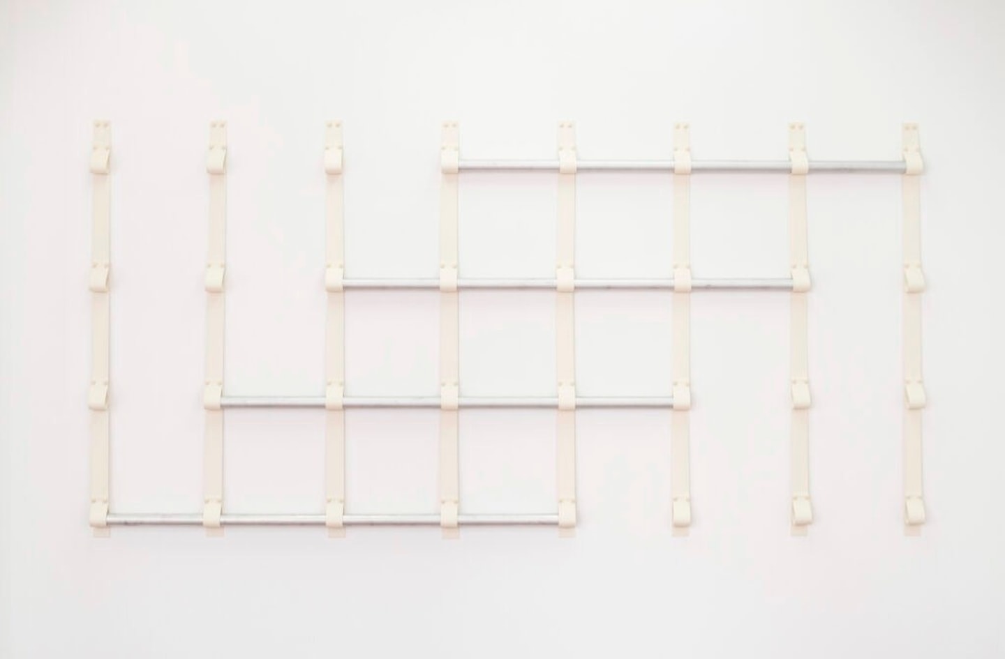 Sterling Lawrence, “Strap Illustration V.2,” 60×100 inches. Natural gum rubber, hardware and aluminum pipe.