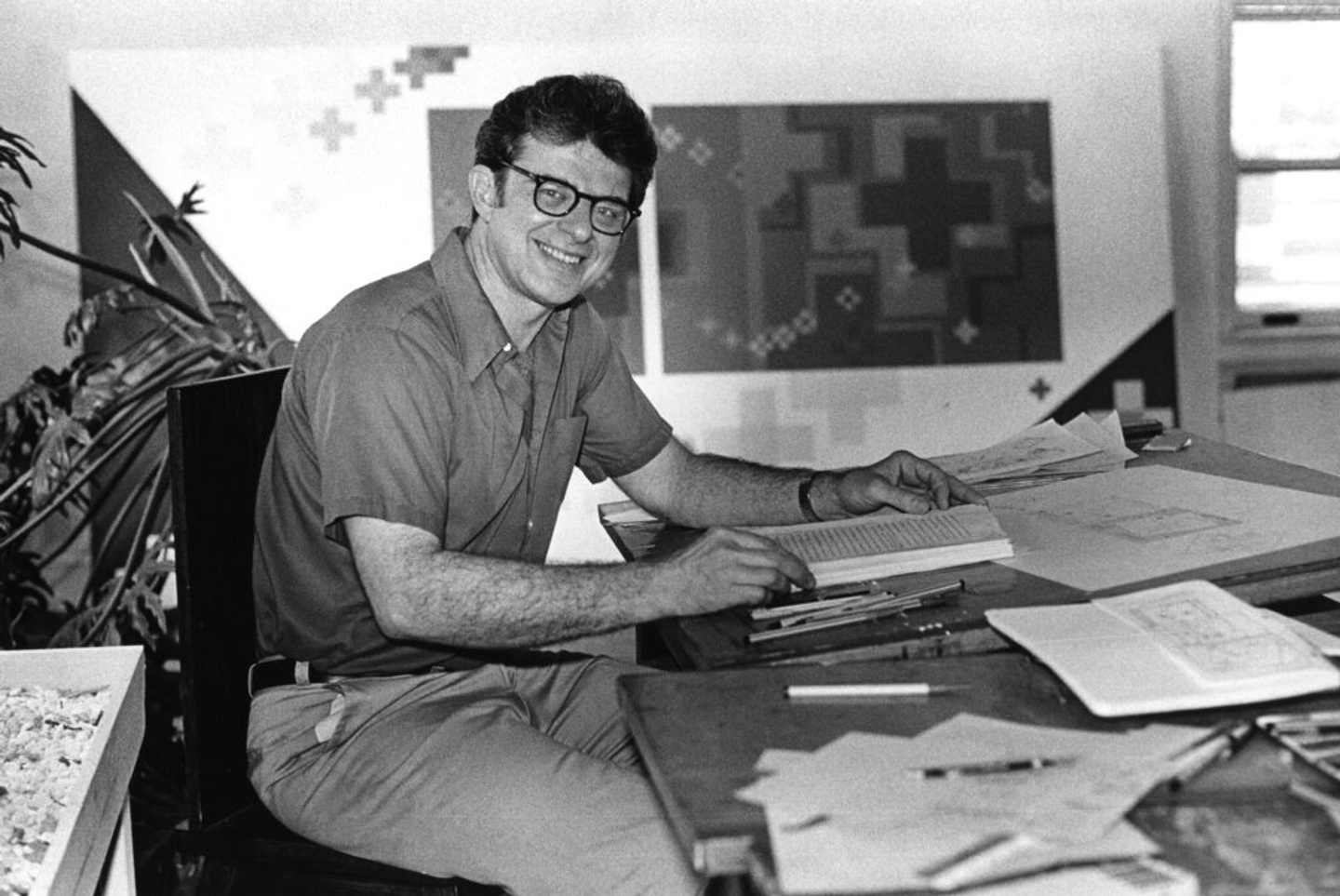 Krukowski, smiling, at his drafting table
