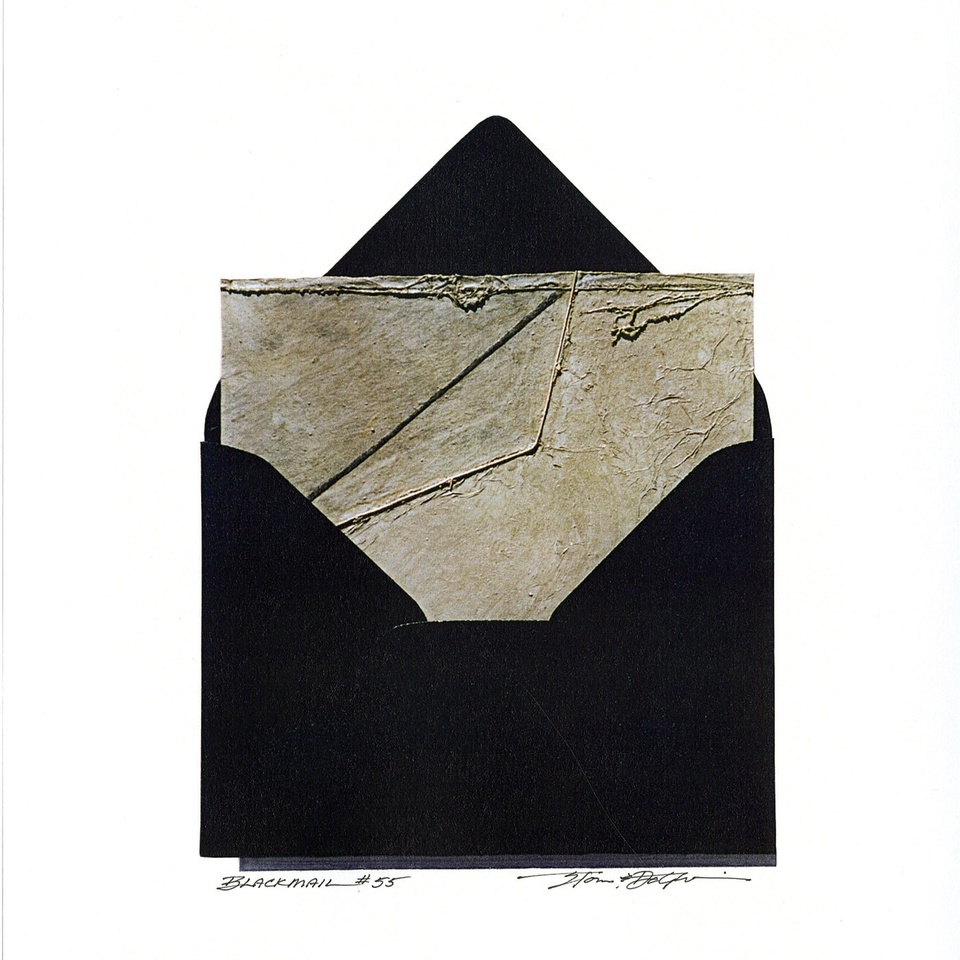 An open black envelope revealing a textured piece of gray paper sticking out.