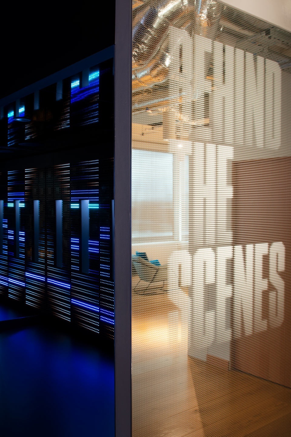 Entrance to an installation, beside a mirror that has the words "Behind the scenes" on it