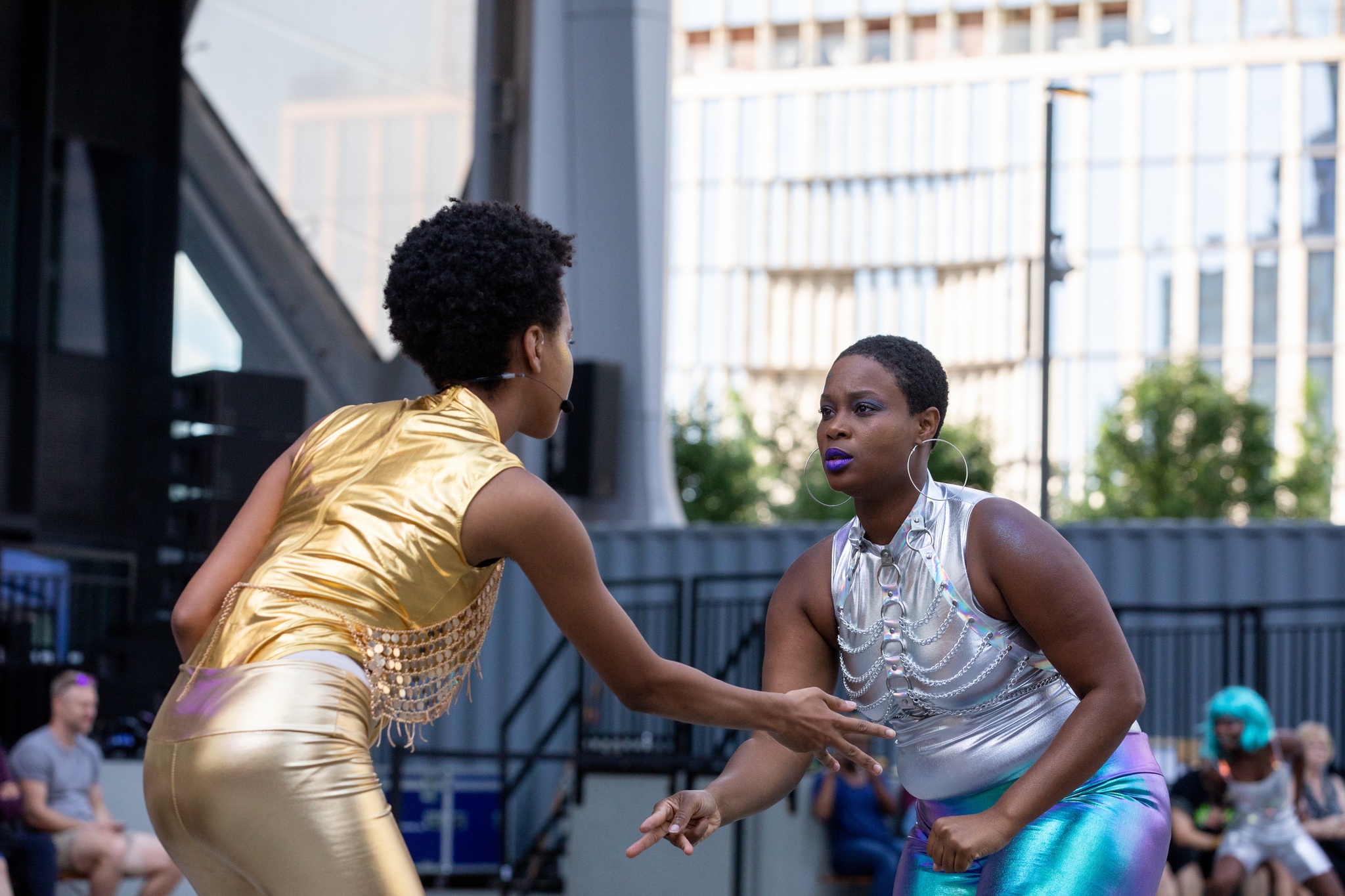 Dancers in motion on an outdoor stage.