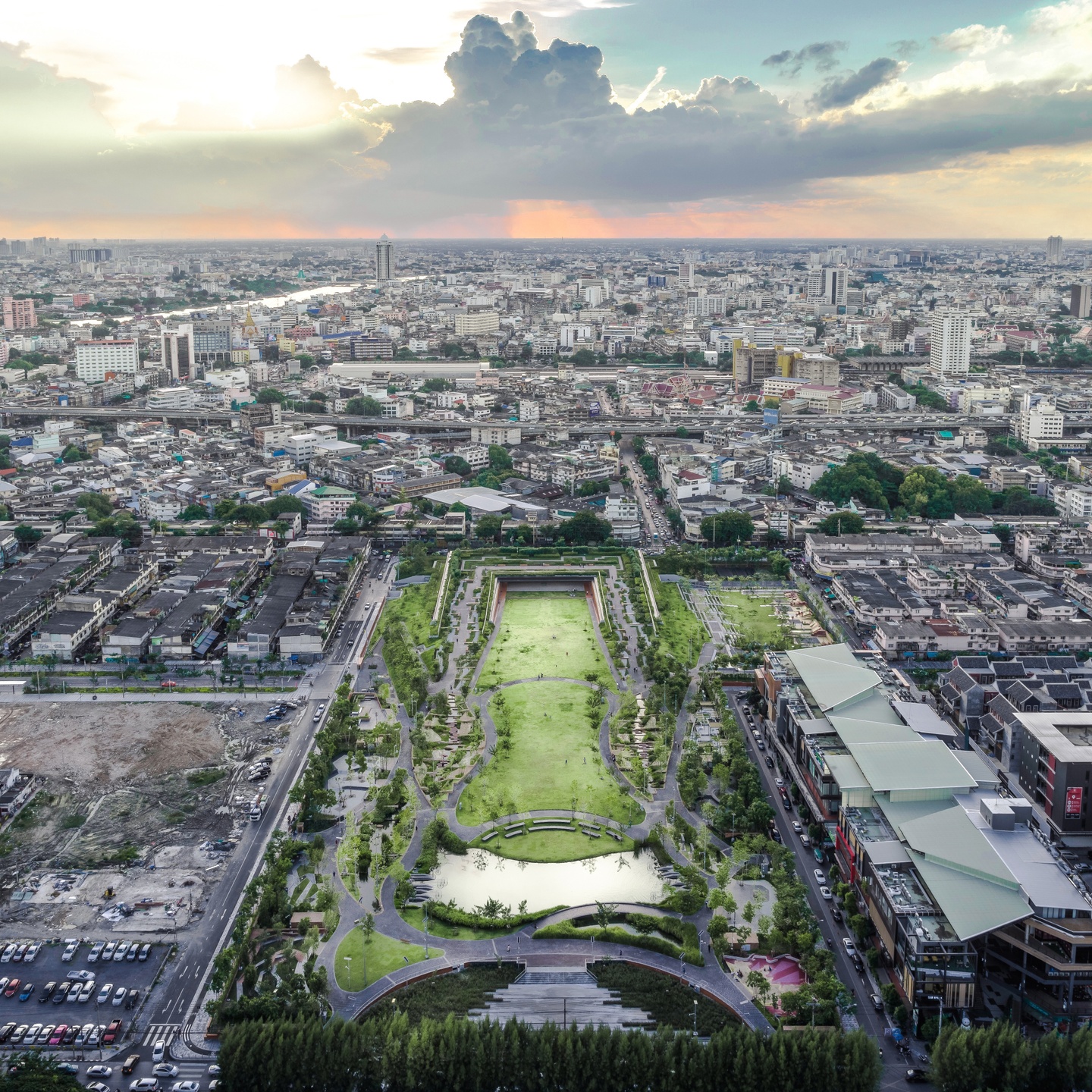 Aerial photo of a tall, rectangular green park area surrounded by a dense urban setting of buildings.