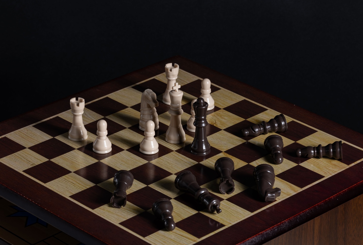 A chessboard lit against a black background.