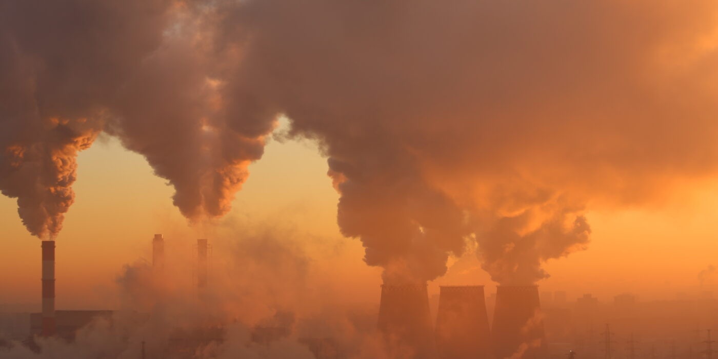 An orange sky with abstracted smoke emerging from unseen several smokestacks.