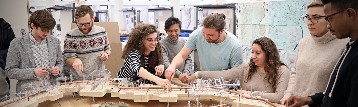 A group of students work together on a model of a city 