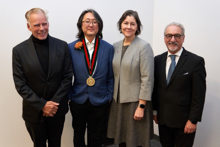 Group of four people standing with Sung Ho Kim