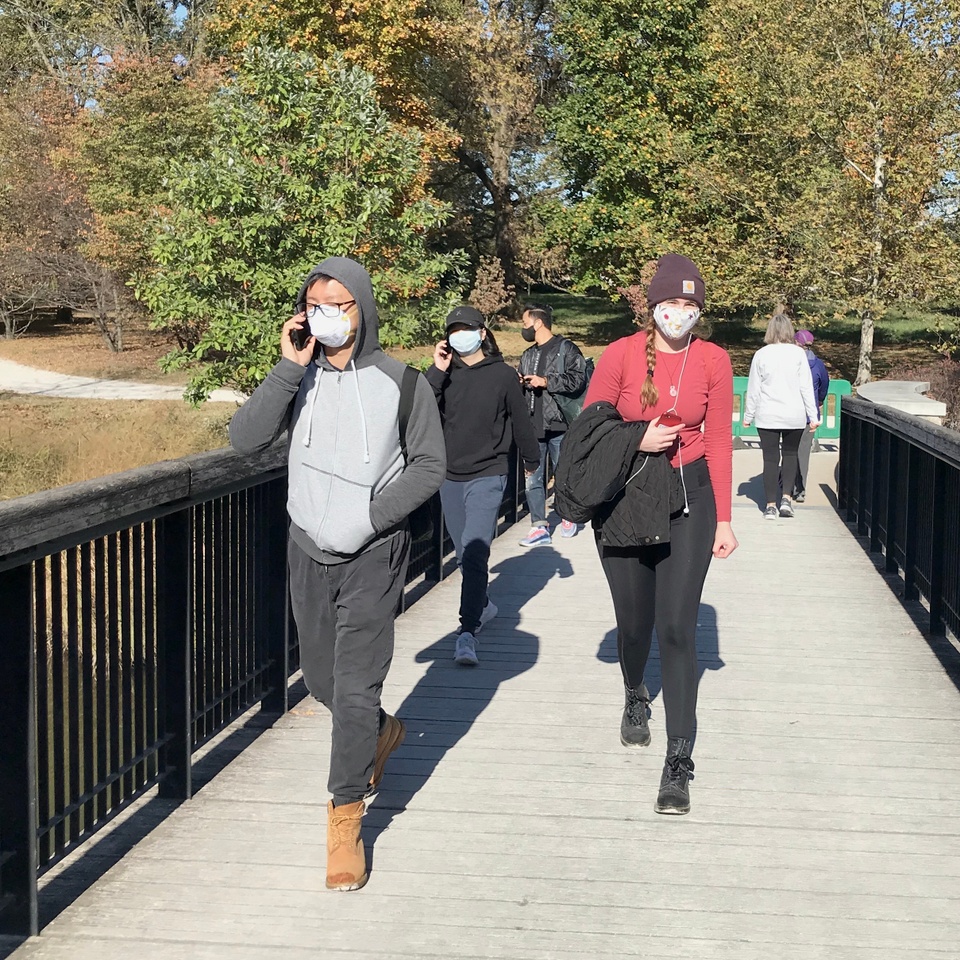 A group of people walk outdoors.