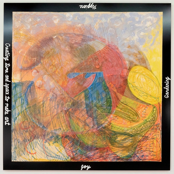 A square artwork made from marker, crayon, colored pencil, and acrylic, with shades of muted orange with bolder red, blue, and yellow shapes over it. A thin black border surrounds all edges of the work, with white script text on each side.