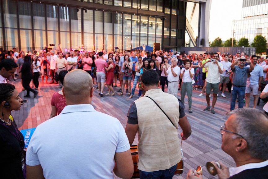 Drummers encircled by lively crowd outside