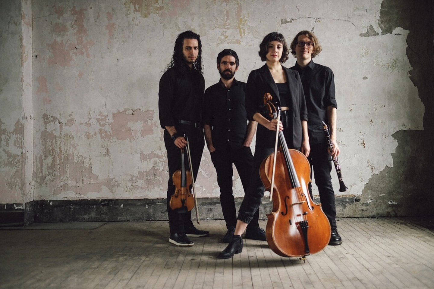 Group portrait of the musical ensemble Unheard-of with their instruments.
