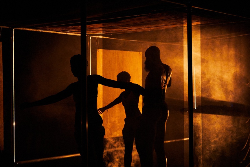 Dancers on a dramatically lit stage.