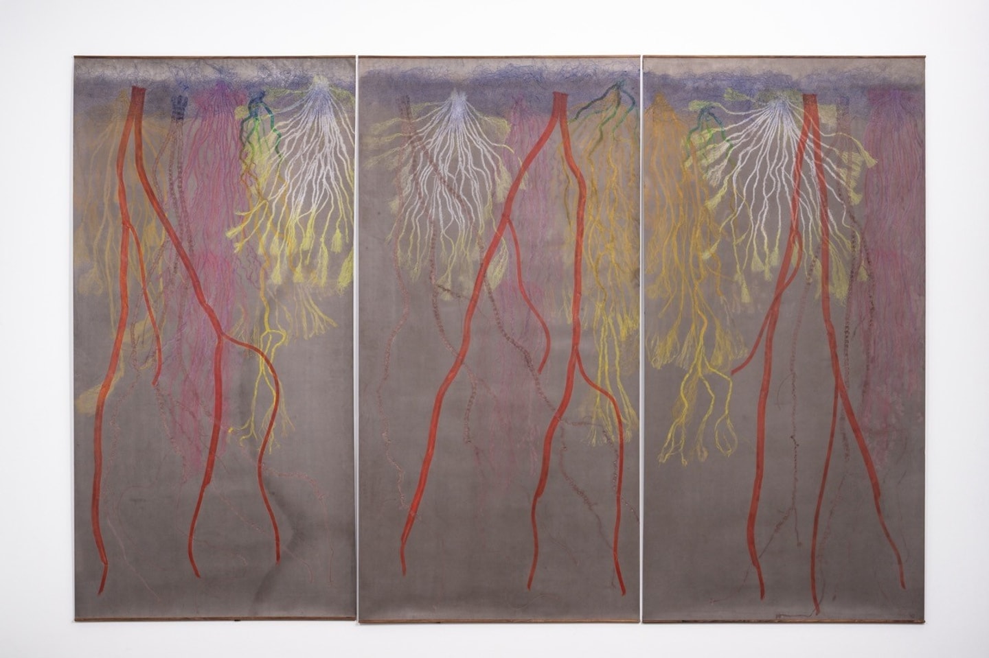 triptych of colorful roots in reds, pinks and yellows starting at the top of the page and tapering off at the bottom