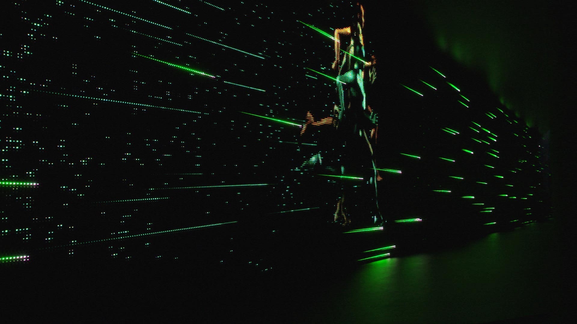 Screen with a larger than lifesize runner and green horizontal lines on a black background