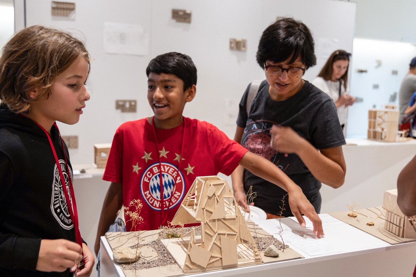 three young students looking at work