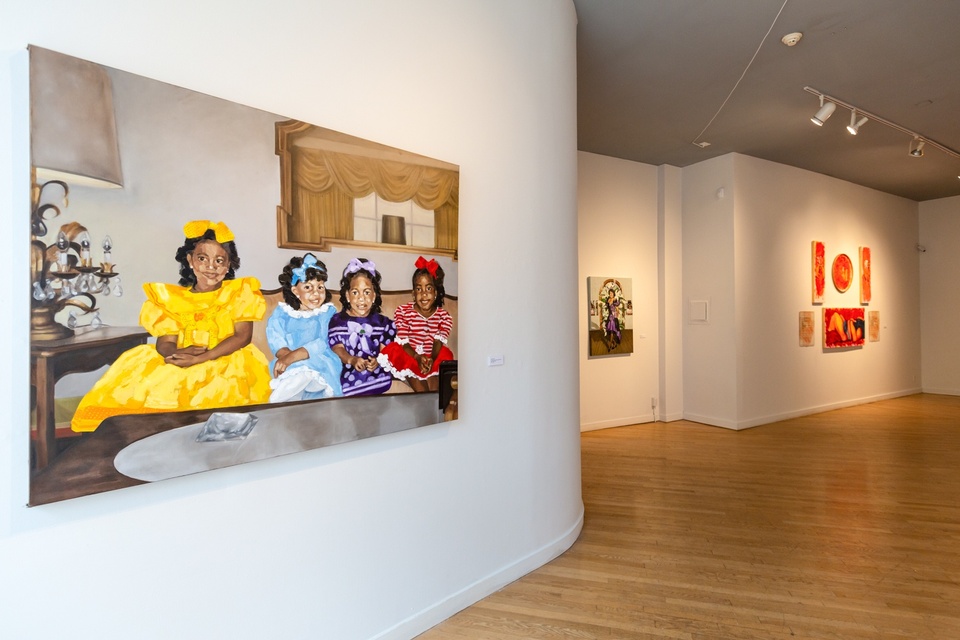 Wide gallery view of 3 paintings. The painting in the foreground depicts 4 young children sharing a sofa in their sunday best