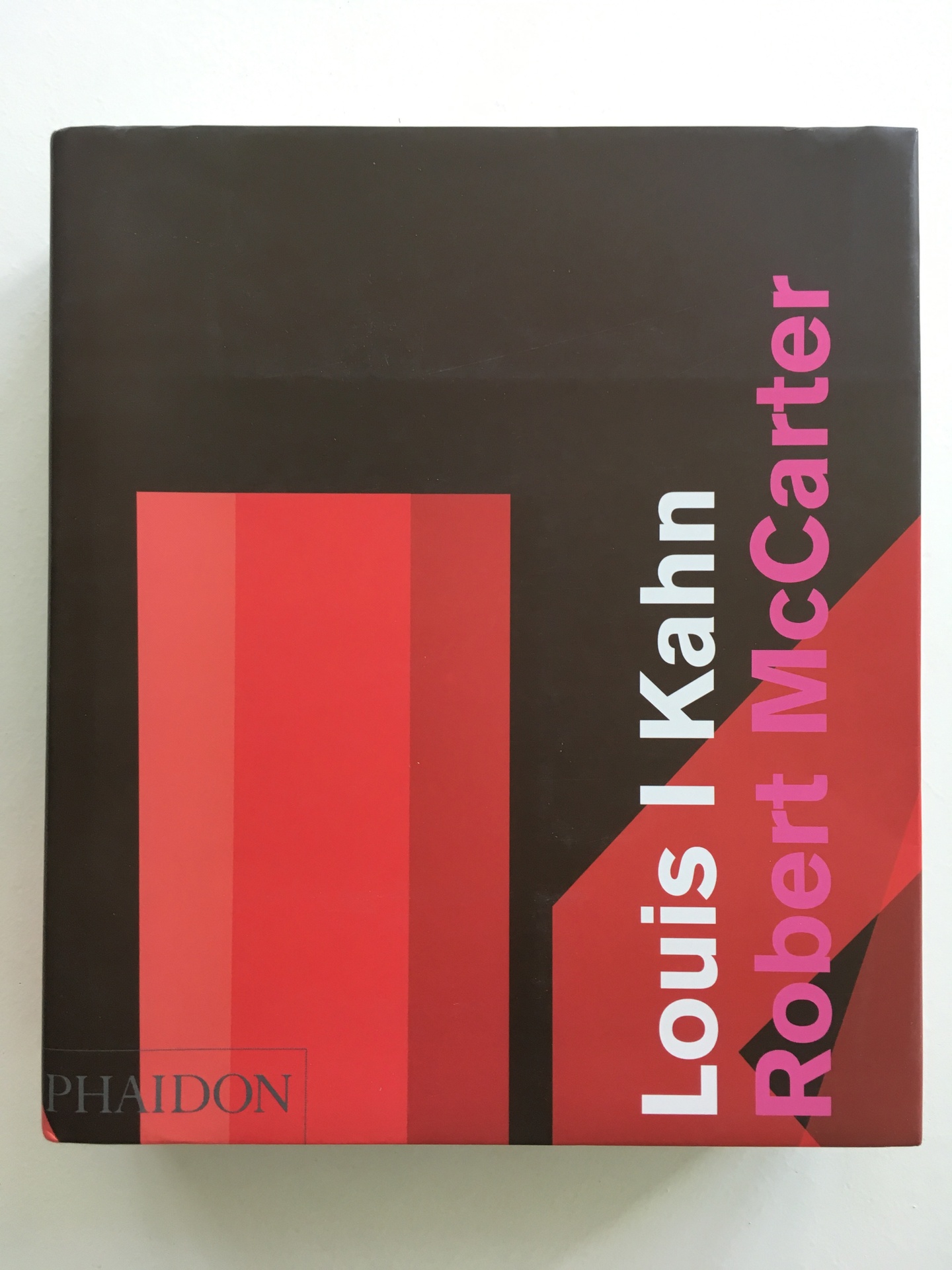 Cover of Louis I. Kahn, featuring a dark background with a multi-hued red rectangle and other red, angled shape.