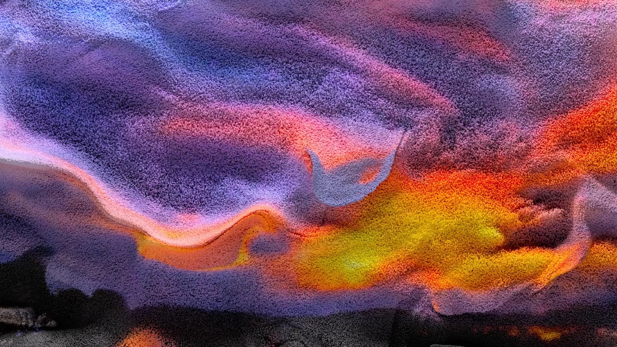 An abstract image that resembles a sandy landscape in the pink, purple, and orange hues of a desert sunset
