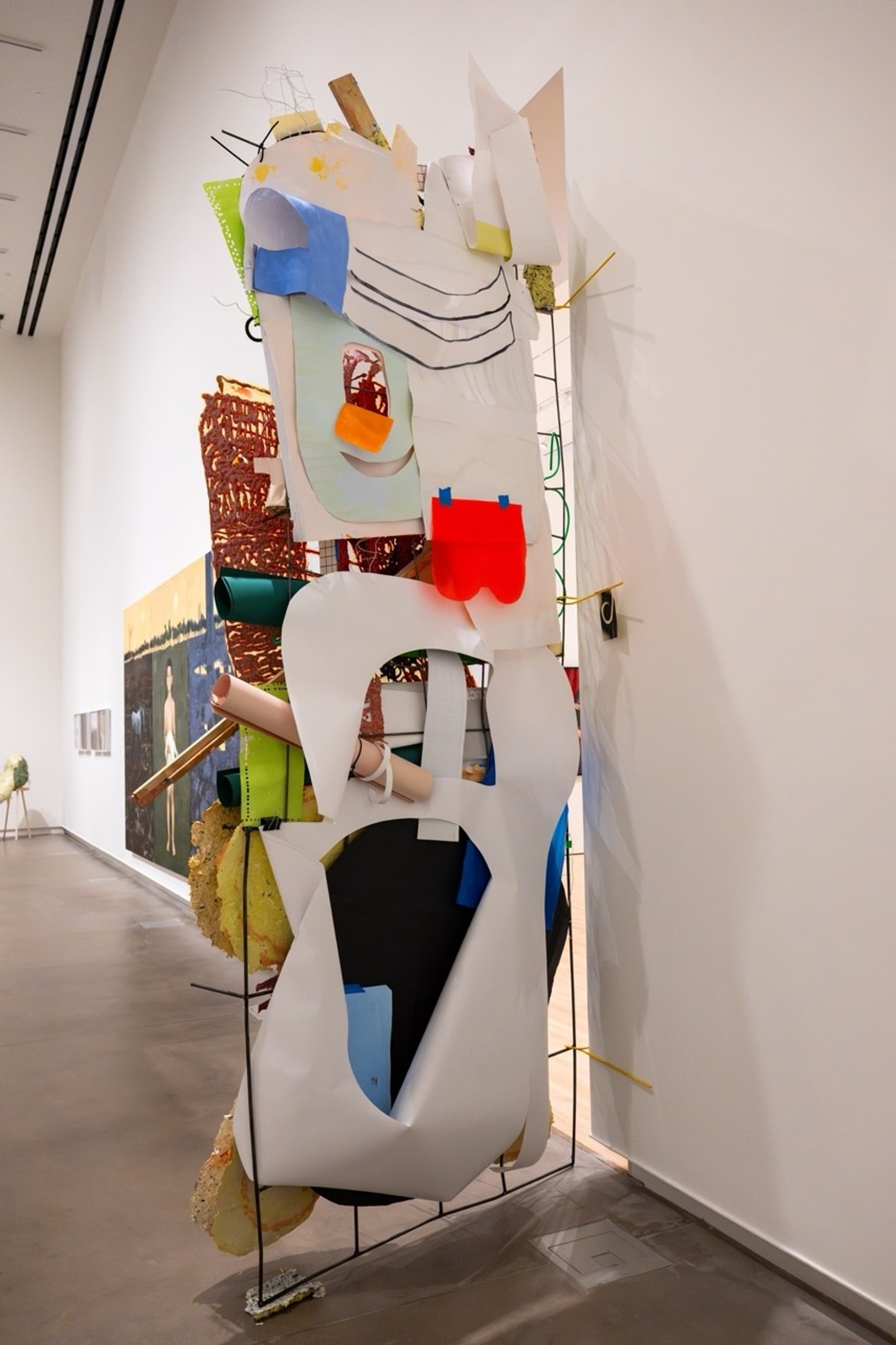 sculptural collage of mixed media such as papers and wires in many colors standing tall