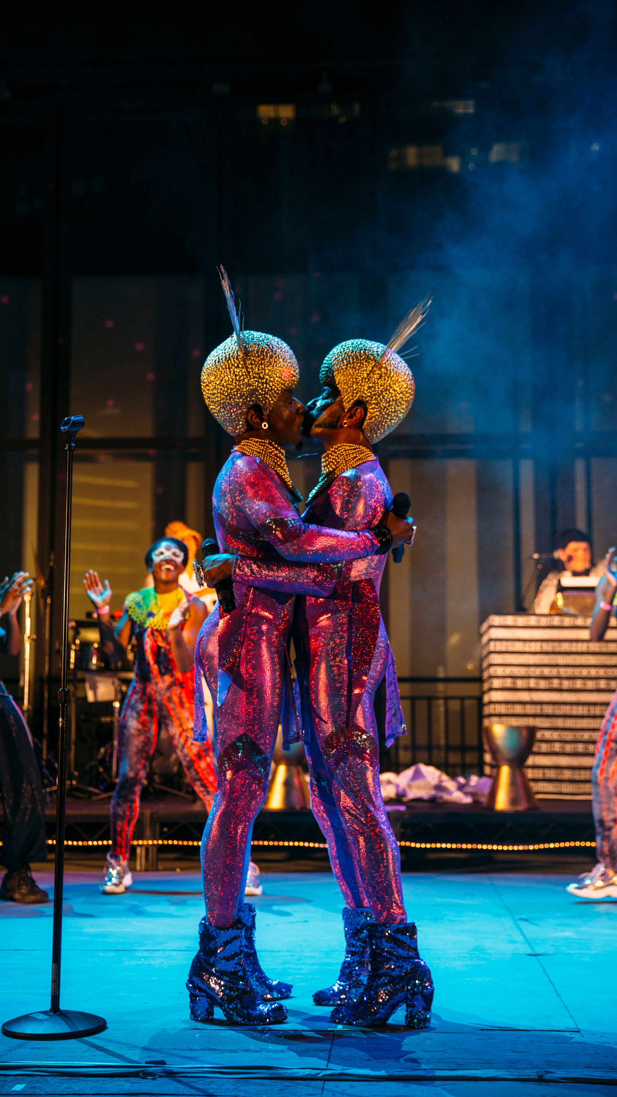 The Illustrious Blacks performing on stage with background dancers.