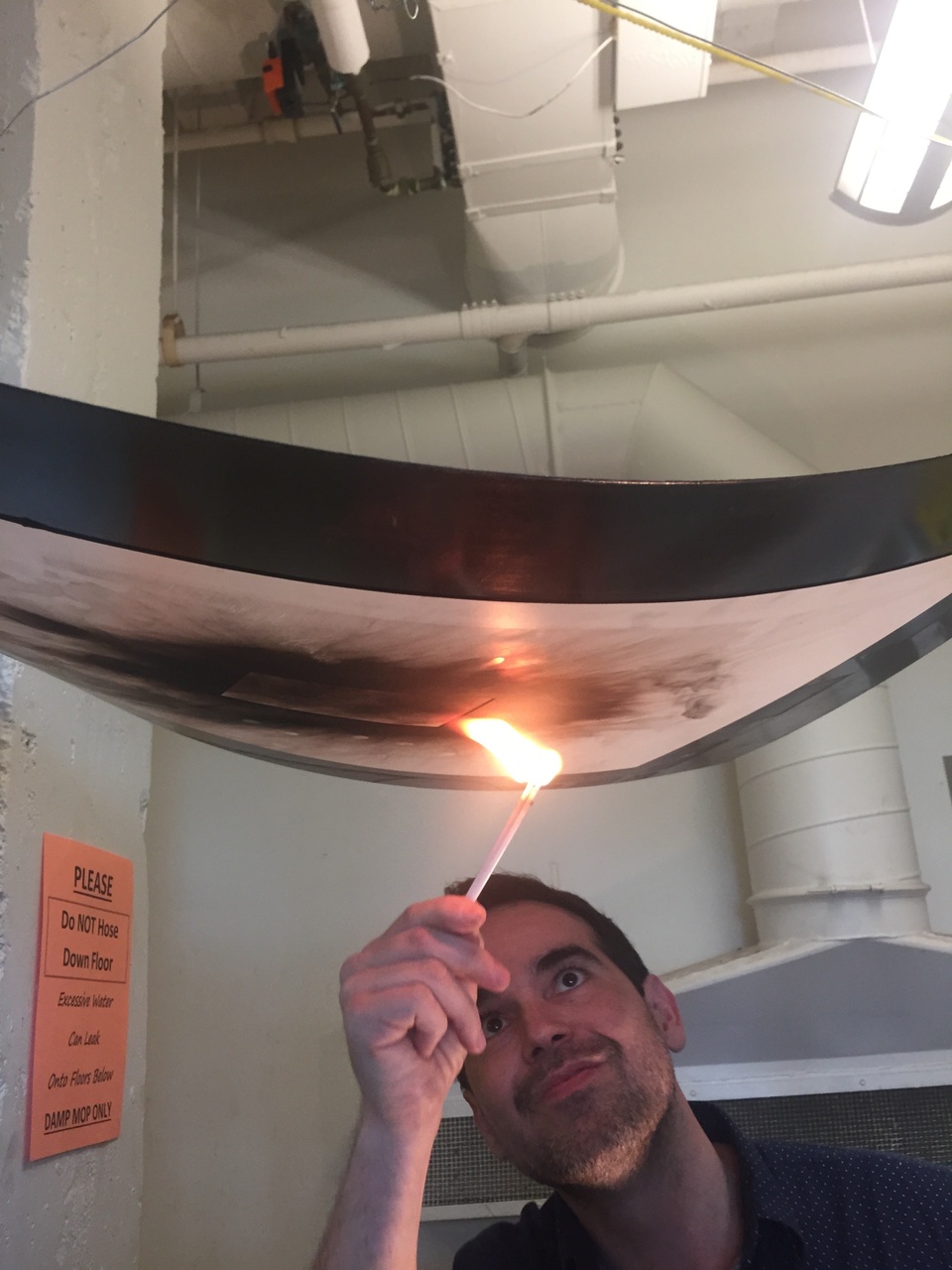 Artist Dario Robleto applying flame to the paper