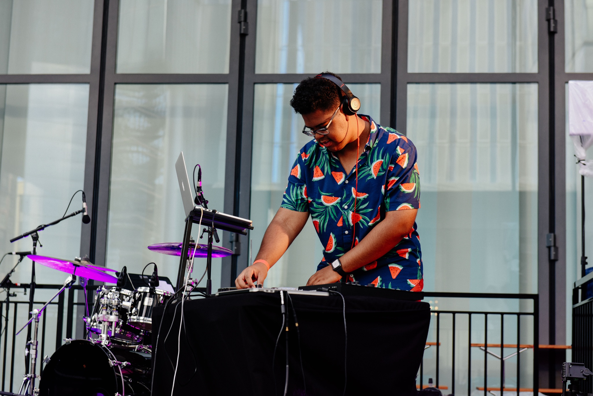 DJ performing on outdoor stage.