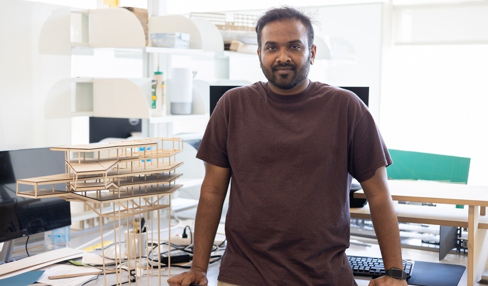 Bob Inapanuri in his studio next to a balsa wood model