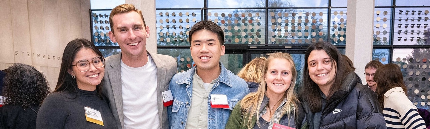 Five people pose in Steinberg Hall