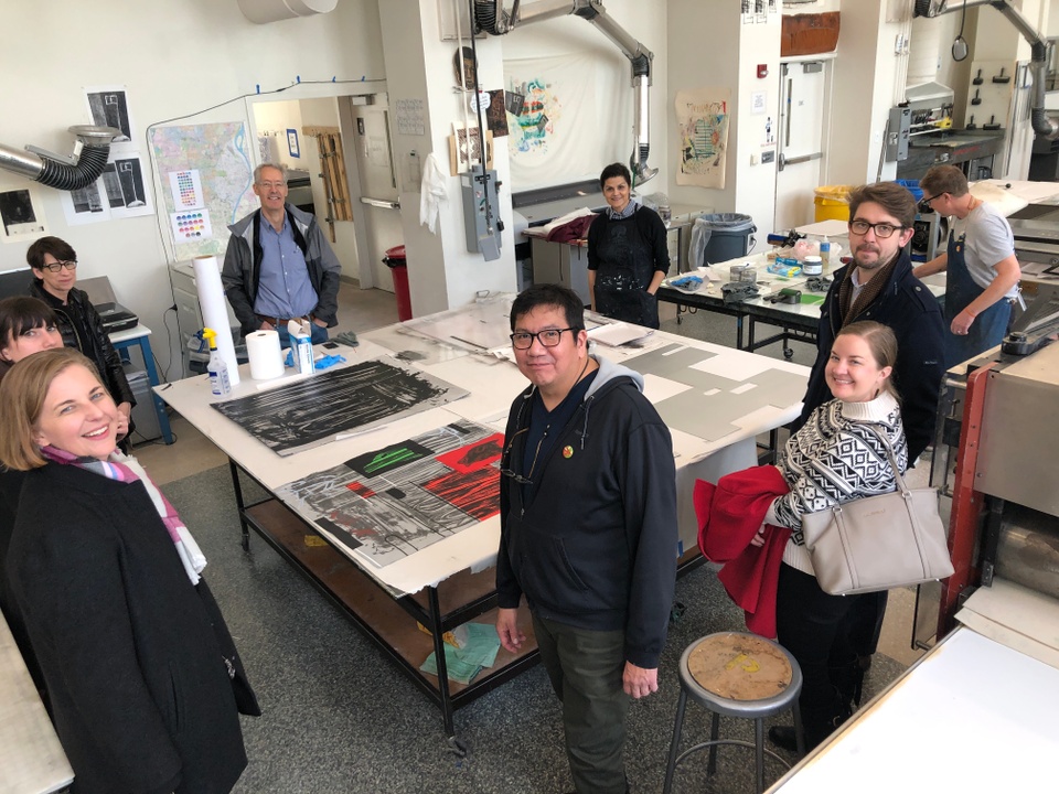 View of print shop with visitors meeting artist