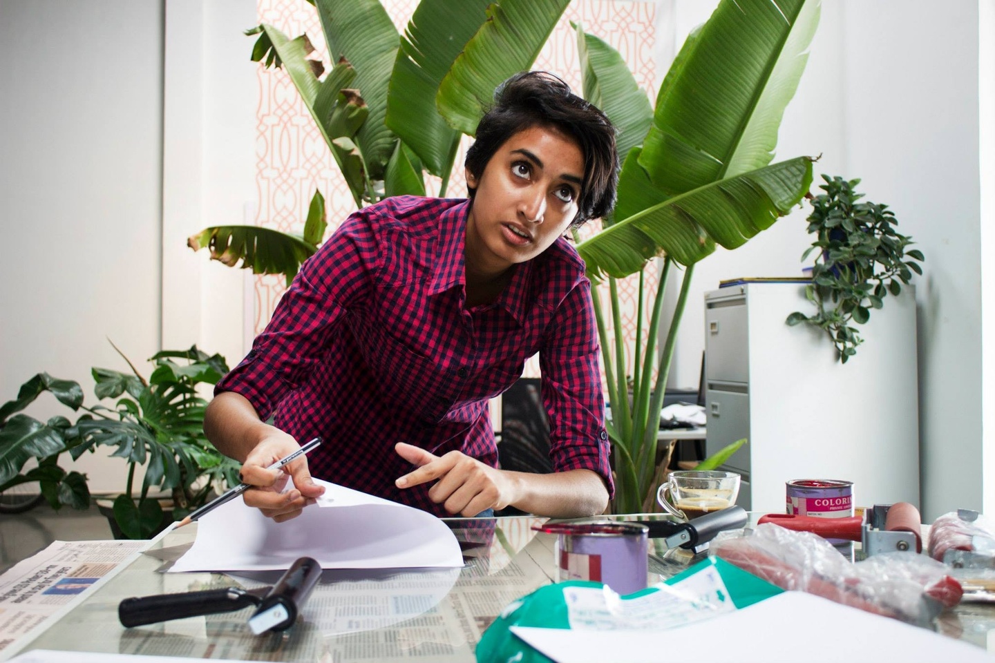 Portrait of Shreyas R Krishnan seated in studio, working on an illustration.