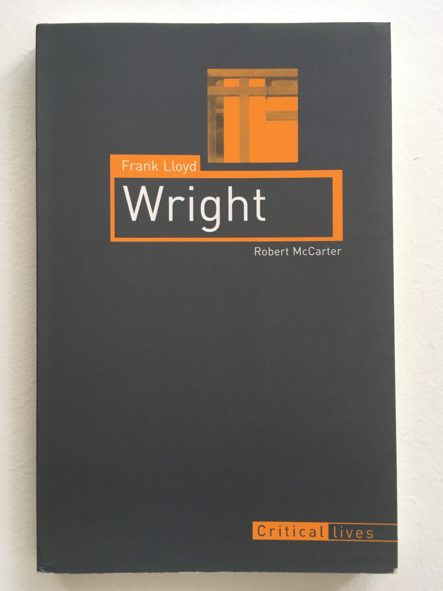 Cover of Frank Lloyd Wright, with a charcoal gray cover and orange detailing
